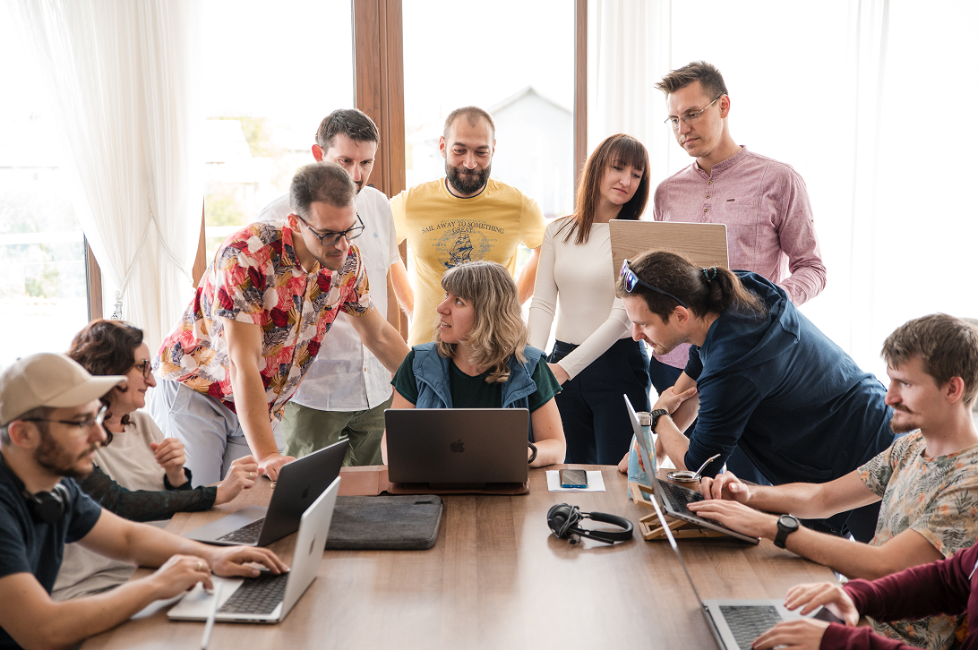 A small team watching a live product webinar together in a sunlit office